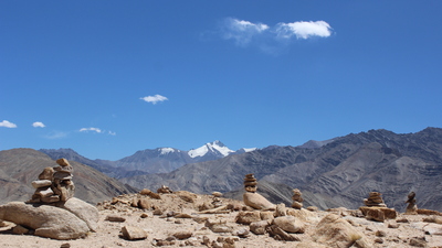 Stone piles on the plateau above Basgo. Stok Kangri in the distance